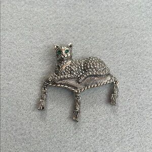 Charming Silver Cat Brooch with Green Accents